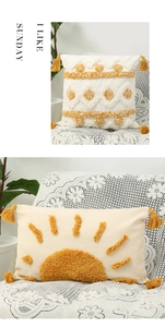 Detail of bohemian tufted cushion covers with geometric sun patterns and tassels
