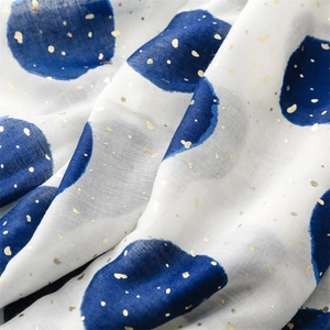 Detail of cotton linen feel scarf with blue polka dots and golden metallic foil accents