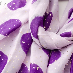 Detail of lavender cotton-linen scarf with large purple dots and metallic gold foil accents
