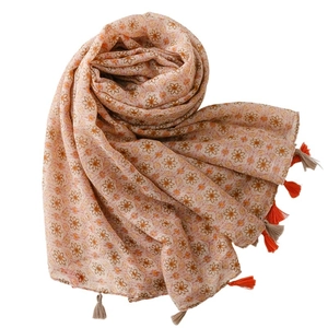 Spring silk scarf with sun flower prints and decorative tassels on white background
