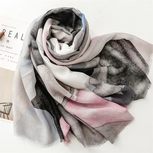 Close-up of lightweight cotton linen scarf with geometric pattern and frayed fringe trim