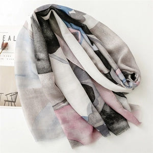 Detail of lightweight cotton linen scarf with geometric abstract patterns and fringed edges