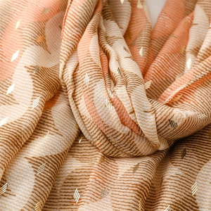 Detail of wavy cotton linen feel scarf with gold foil diamonds and frayed edges