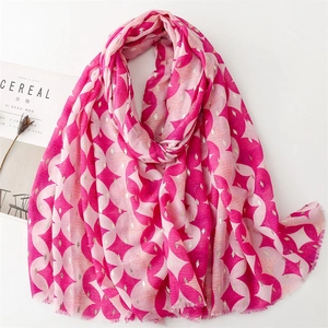 Detail of fuchsia geometric cotton-linen scarf with gold foil accents and frayed edges