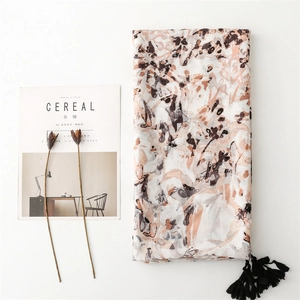 Minimalist long scarf with artistic floral prints and tassels on white background
