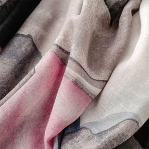 Macro detail of geometric print cotton linen scarf with soft texture and frayed edges