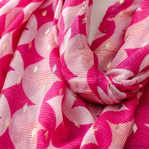 Detail of pink geometric scarf with metallic gold foil accents and soft fabric texture