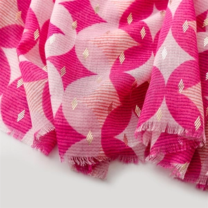 Detail of soft cotton-linen scarf with geometric pink patterns and gold foil texture