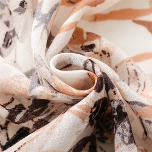 Macro shot of abstract floral print scarf fabric with soft texture and frayed edges