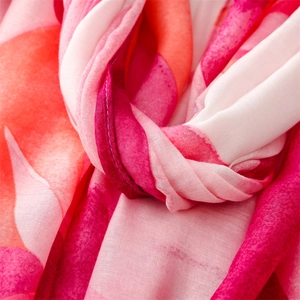 Macro shot of abstract geometric pink scarf fabric texture with fine frayed edges