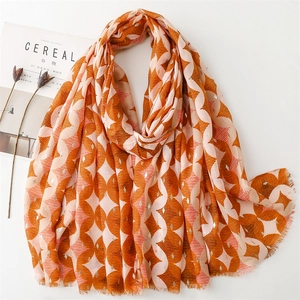 Linen feel scarf with gold foil geometric wave pattern and fringe in orange and pink