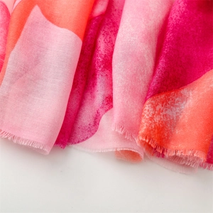 Detailed macro shot of gradient geometric patterns and frayed edges on cotton-linen scarf