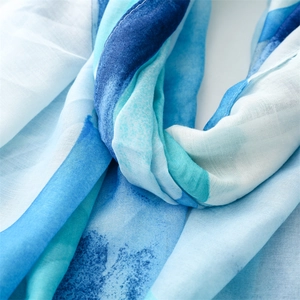 Detailed macro view of the blue and white artistic print on lightweight cotton linen scarf