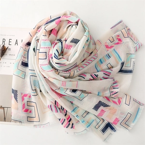 Close-up of geometric print scarf with frayed edges and colorful artistic patterns