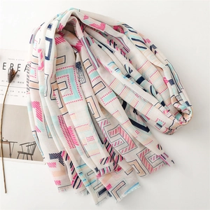 Detail of thin cotton linen scarf with colorful geometric patterns and fringe edges
