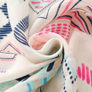 Close-up of lightweight cotton scarf with vibrant colorful geometric patterns and soft texture