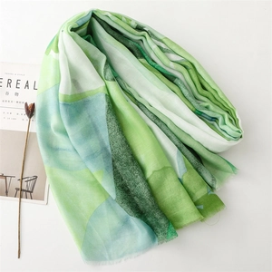 Detail of watercolor print cotton-linen scarf featuring artistic fringed edges on white background