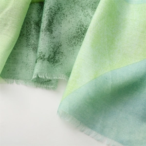 Close-up of lightweight gradient scarf with fray edges and breathable cotton linen texture