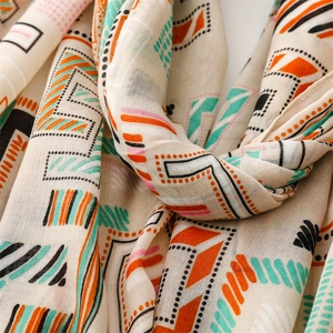 Detail of thin cotton linen scarf featuring colorful geometric prints and soft texture