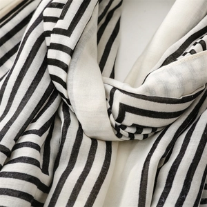 Detailed macro view of black and white striped linen-feel scarf showing fabric texture