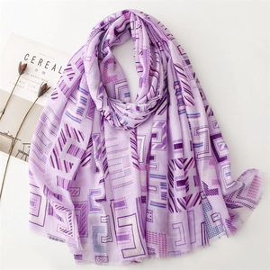 Flat lay of light purple cotton linen scarf with geometric patterns and fringe detail