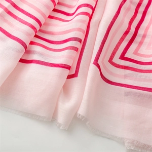 Detail of pink and red striped cotton-linen scarf with delicate fringe edge texture