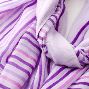 Close-up of lightweight purple striped linen-feel scarf with soft texture and frayed edges