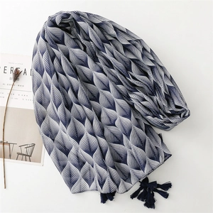 Blue and white patterned voile scarf with fringe tassels for sun protection and travel