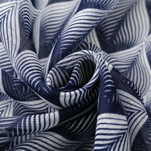 Detailed macro view of navy blue and white geometric patterns on breathable scarf fabric