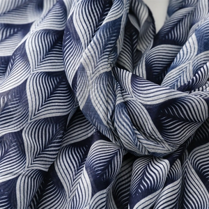 Detailed close-up of blue and white leaf pattern on lightweight breathable fabric shawl