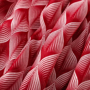 Detail of red voile shawl showing delicate white leaf patterns and woven texture