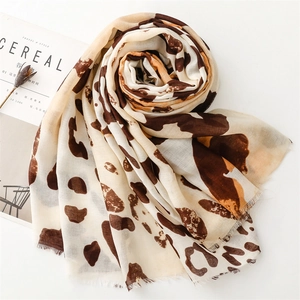 Detailed view of lightweight leopard print scarf with soft frayed fringe edges