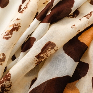 Close-up of lightweight leopard print scarf fabric showing thin texture and frayed edges