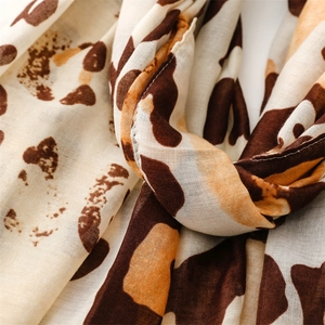 Close-up of leopard print scarf fabric showing soft drape and fine texture