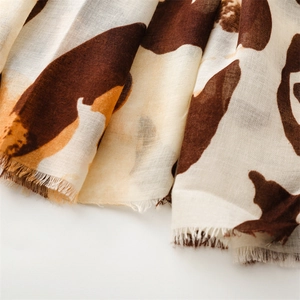 Detail of soft leopard print cotton scarf showing frayed edges and textured fabric weave