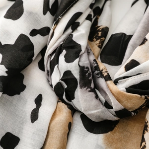 Detailed macro view of leopard print lightweight fabric texture and woven scarf edges