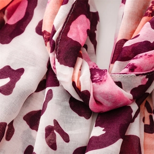 Close-up of pink leopard print scarf showing fine fabric texture and neat stitching