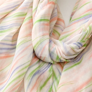 Detail of breathable linen-feel scarf showing soft pastel watercolor stripes and texture