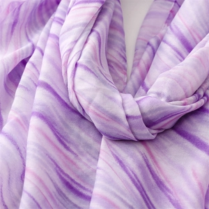 Detail of soft purple fluid marble pattern fabric with elegant draping and light texture