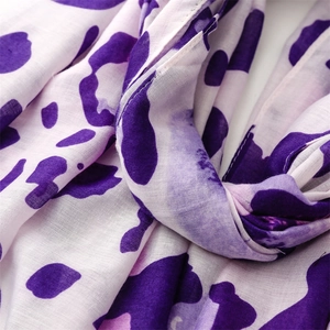 Macro detail of purple leopard print cotton linen fabric with soft woven texture