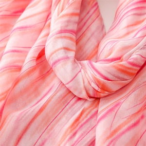 Detailed texture of pink and orange marble pattern on a soft chiffon scarf fabric