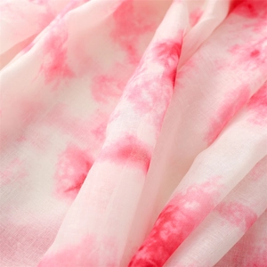 Gros plan détaillé du tissu dégradé rose et blanc en mousseline avec texture douce