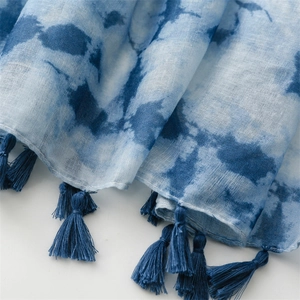 Detailansicht des Schals mit blauem Farbverlauf, feiner Textur und weichen Fransenquasten