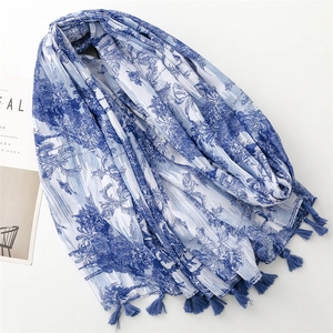Blue porcelain style scarf with floral tropical prints and tassels on white background
