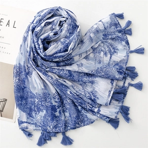 Blue and white landscape print scarf with tassels and palm tree patterns for summer