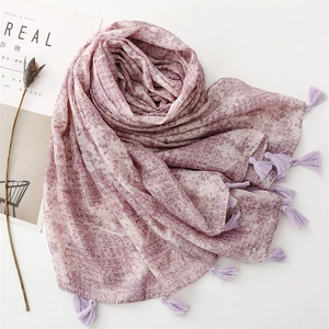 Elegant lavender scarf with gold foil accents and tassel edges on minimalist background