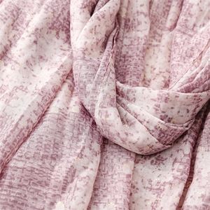 Macro shot of purple mosaic patterned shawl with delicate gold foil stamping details