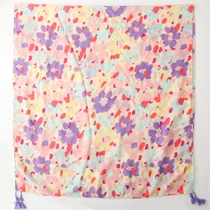 Linen-touch shawl featuring colorful watercolor floral prints and purple tassel fringe accents