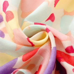Soft cotton-linen feel scarf with colorful floral patterns and decorative tassels