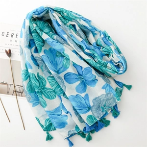 Detailed view of floral print scarf with soft tassels and minimalist Cereal magazine decor